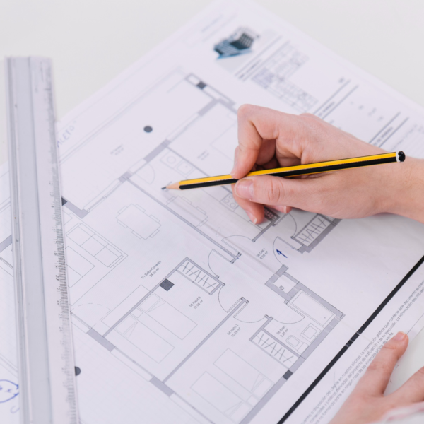 Designer using a floorplan to measure for cold room